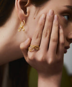 Tiny Fiocco Earrings: A small everyday hoop, following the shape of the bestselling Fiocco Earrings. The earrings strike a balance between abstract minimalism. By London based Bar Jewellery, using recycled silver