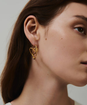 Sweetheart Hoop Earrings: An abstract hoop, revealing a subtle heart shape at just the right angle. The earrings are classic with a playful, feminine touch. By London based Bar Jewellery, using recycled silver