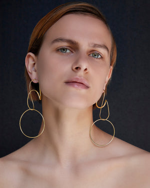 
            
                Load image into Gallery viewer, BAR Jewellery Sustainable Opposing Forms Earrings In Gold Drop Style, Placed On Ear
            
        