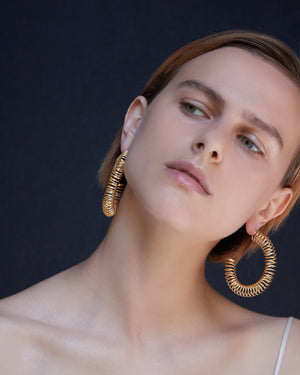 
            
                Load image into Gallery viewer, BAR Jewellery Sustainable Roule Earrings In Gold Hoop Style, Placed On Ear
            
        