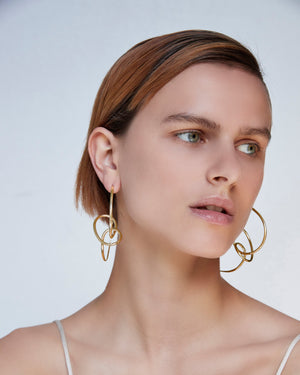 
            
                Load image into Gallery viewer, BAR Jewellery Sustainable Statement Sfera Earrings In Gold, Placed On Ear
            
        